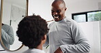 Bathroom, dad and talking to son, oral health or instruction for grooming in home, learn or routine. Teaching, wellness and hygiene of mouth, black man and boy with bamboo toothbrush for dental care