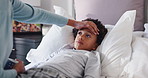 Parent, sick child and fever with thermometer in bed for illness, influenza or allergy in home. Hand, kid and son with guardian checking temperature for monitoring flu, cold or symptoms in bedroom