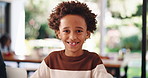 Face, home and boy with smile, child and relax in lounge, weekend break, bokeh and calm. Portrait, apartment and African kid in living room, happiness and funny with humor, laughing and vacation