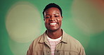 Black man, face and smile in studio with green background, pride and confidence on bokeh. Happy person, portrait and joy or positive, laugh and relaxed with funny joke isolated in mockup space