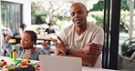 Man, laptop and video call with child for remote work from home, multitasking and happy for toys. African dad, boy and distraction with blocks, smile and talk for freelance consulting at family house