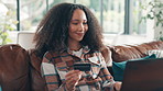 Home, credit card and woman on sofa, laptop and ecommerce with online shopping. Apartment, fintech account and person with pc, transactions and web finance with payment, banking and discount deal