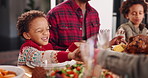 Happy boy, holding hands and praying with food for family feast, thanksgiving or meal in home. Child, kid or faith with gratitude or appreciation for festive dinner, dining or get together in house