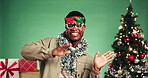 Christmas, face and man with smile, dancing or excited for celebration, happiness or festive season. Green background, studio and rhythm for December holiday and black person with xmas sunglasses