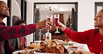 Family, dinner and cheers for Christmas, home and beverage for celebration, smile or festive season. Happy, man and toast with woman, feast and bonding on Xmas holiday, child and parents with drinks
