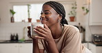Happy, black woman and thinking with coffee in kitchen for good morning or breakfast drink in home. Female person, smile and satisfaction with cup or mug of caffeine for start or daydreaming in house