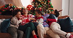 Laughing, family and celebration of Christmas, home or bonding on festive season, love and December. Happy, man and woman with children on Xmas holiday, tickling and fun with kids, lounge and house
