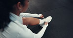 Above, shoes and laces in gym for fitness, run or start exercise routine with woman for health. Person, athlete and ready for workout, training or sports with tying sneakers for preparation at club