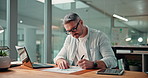 Writing, documents and business man on laptop for financial planning, revenue growth and profit. Company, paperwork and person on computer with statistics, graph and infographics for finance report