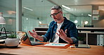 Laptop, video call and writing with business man in office for development, discussion or planning. Computer, notebook and virtual meeting with mature employee at desk in workplace for communication