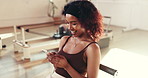 Phone, laugh and woman in pilates class for fitness, reading meme or social media break. Mobile, exercise and person at gym club for communication, funny notification and typing text with online app