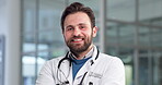 Doctor, face and man with smile in clinic for medical service, health support and medicare confidence. Medicine, cardiologist and happy in hospital for healthcare work, about us or proud professional