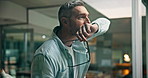 Man, thinking and stress at window, office or reflection for mistake, decision or memory at company. Mature person, worry and insight with problem solving for crisis, anxiety or solution at agency
