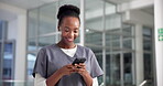 Doctor, woman or typing with phone in clinic for telehealth, healthcare update or research. Medicine, black person and smile with smartphone in hospital for planning schedule or reading health report