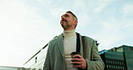 Coffee, thinking and business man in city, below and confidence with pride, calm and urban town. Mature person, outdoor and entrepreneur with career ambition, idea and herbal tea with morning commute