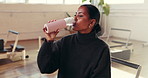Woman, fitness or drinking with water bottle or break for hydration, rest or recovery in gym. Active, female person or thinking with mineral liquid or thirst for natural sustainability in health club