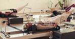 Mature woman, pilates and reformer machine, workout and routine with fitness class at club. Person, gym equipment and resistance band for strength training, muscle or exercise at wellness studio