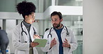 Doctor, medical team and walking with tablet in hospital for healthcare planning or collaboration. Man, woman or health employees with technology for discussion, conversation or procedure in clinic