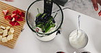 Blender, fruits and hands of woman with spinach in kitchen for smoothie with health, wellness or breakfast. Nutrition, morning and person with organic ingredients for protein shake in apartment.