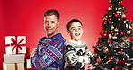 Family, face and smile for Christmas with father, child and festive cheer for bonding in studio. Arms crossed, portrait and dad with son for xmas celebration, presents or decoration on red background