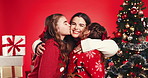 Christmas, face and children kiss mother for love, care or hug on red studio background. Xmas, mom and embrace happy girls, kids or sisters with parent for holiday celebration with family portrait