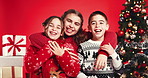 Happy, christmas and face of children hugging in studio for bonding, connection or family. Smile, love and portrait of kid siblings embracing for xmas tradition or festive season by red background.