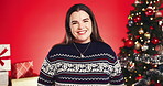 Christmas tree, face and smile of woman on red background for festive excitement or tradition. Celebration, event and season with happy person in studio for gifts or presents in December holidays