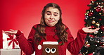 Shrug, christmas and face of child in studio with decision, thinking or guess for festive season. Happy, dont know and portrait of girl kid from Italy with choice for xmas holiday by red background.