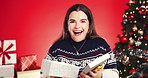Surprise woman, face and christmas with gift box in studio for giving or offer on a red background. Portrait, female person or model with smile for present, festive celebration or december holiday