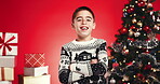 Holiday, face and child with smile, Christmas or excited for festive season, arms crossed or studio. Red background, confident and boy with Xmas sweater, December and happy for celebration in USA