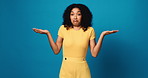 Face, confused and woman in studio, shrug and body language with questions on blue background. Portrait, space or person with facial expression, reaction or whatever with hand gesture, doubt or emoji