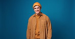 Face, smile and man with casual fashion, mockup and confidence on blue background in studio. Portrait, happy Gen z person and aesthetic with trendy, outfit style and comfortable clothes on space