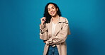 Face, woman and proud with fashion in studio for casual clothes, positive attitude and minimalistic. Mockup space, person and laughing with confidence, trendy outfit and cool style on blue background
