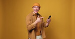 Man, reaction and excited with smartphone, pointing or shocked by good news, online or mockup space. Studio background, surprised and hand gesture for notification, smile or communication with mobile