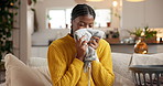 Home, smelling and black woman on sofa, folding laundry and satisfied in living room. Apartment, housekeeping and African person on couch, fabric scent and clean clothing with maintenance and aroma
