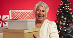 Xmas, face and old woman in studio, gift and laughing with holiday season on red background. Christmas, win giveaway and senior person with tradition, presents or funny with smile, festive or package