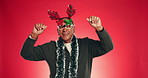 Christmas, dancing and face of senior man in studio with decoration for holiday or festive season. Happy, mockup space and portrait of mature person with energy for xmas celebration on red background
