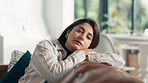 Serious, woman and relax with thinking on sofa for problem solving, reflection and nostalgic memory. Peaceful, person and thoughtful in living room with remember, wondering and contemplating in home