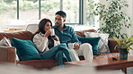 Couple, coffee and watching tv with talking on sofa for movie review, bonding and streaming service. Relax, people and drinking beverage in home with film subscription, weekend break or entertainment