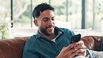 Happy, man and communication with smartphone, lounge and texting with contact, app and social media. Smile, person and chat with mobile in living room, online and typing message on website in home