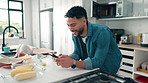 Happy man, typing and kitchen with phone for recipe, research or online food vlog in home. Male person, browsing and texting with smile on mobile smartphone for cooking app, ingredients or meal prep