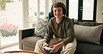 Boy, child and face on sofa with video game controller, headphones or smile with online contest at home. Kid, gamer and happy with mic on couch for portrait, challenge and esports at house in Spain