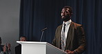 Speech, black man and politician on a stage for election, democracy or political campaign. Talking, microphone and African male speaker at conference, meeting or seminar for vote for activism.