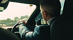 Business, driving and travel with man in car for transportation to job or work location. Commute, road and traffic with mature corporate employee in vehicle for morning journey to destination