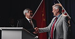 People, handshake and flag at election meeting for respect, political agreement and alliance b2b. Men, shaking hands and deal for diplomacy, international negotiation and global peace with government