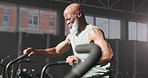 Mature black man, cycling and gym with workout, fitness equipment and challenge by window at club. African person, bicycle and exercise for wellness, health and routine for cardio at training center