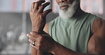 Wrist pain, exercise and mature man in gym with accident for workout, training and fitness. Sports center, hands and person with injury, sprain and inflammation for tendinitis, joint ache and strain