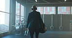 Headphones, gym and back of woman with bag ready to start training, exercise and workout. Sports, practice and person with gear, water bottle and kit for health, wellness and fitness with music
