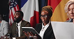 Global, delegation and people for speech with flags for international peace, politics and conference. Tablet, panel and speakers for government summit, politician event and diplomacy discussion