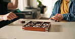 Hands, child and tic tac toe in home with win, celebration or problem solving game for bonding. People, kid and parent with fist pump, success or goal in contest with wooden xo board at family house